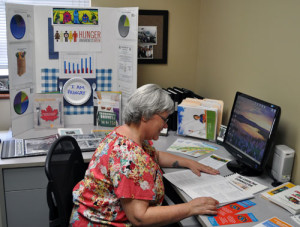 Ever wonder what it's like behind the front counter at Community Connections? Here's Patti Larson at work in her office for a change, though you'd swear she practically lives at the Food Bank. David F. Rooney photo