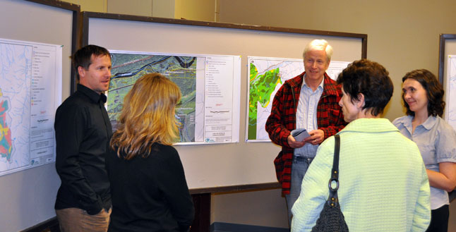 Residents Robin Brooks-Hill and Virginia Thompson talk with the Columbia Basin Trust's Jeff Zukiwsky (left), Revelstoke Environmental Coordinator Penny Page-Brittin (left center) and Patti Amison of Golder Associates (right) about the recent Greeley Creek Source Protection Plan, during an open house last week. David F. Rooney photo