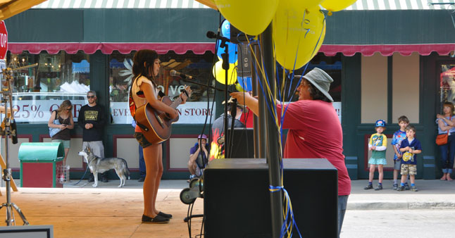 After doing their market shopping, a great many people attended the Relay For Life Kickoff Party on First Street. One of the main features of the party was a talent contest. Here, Wayne Murray adjusts the microphone for your singer Asa DesChamps. David F. Rooney photo