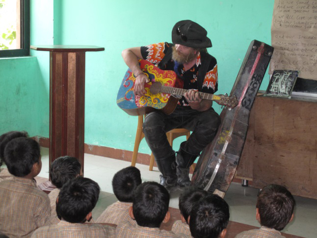 British volunteer, Andy, leads a rousing round of Yellow Submarine by the Beatles. This is one of the children's favorite songs and they sing along with vigour. Laura Stovel photo