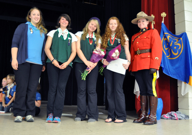 1st Revelstoke Pathfinders Guider Kaleigh Beattie, Linnea Allain, Alexis Allain, Samara Channell pose with RCMP Const. T. Anthony who volunteered to escort the girls to the stage. David F. Rooney photo