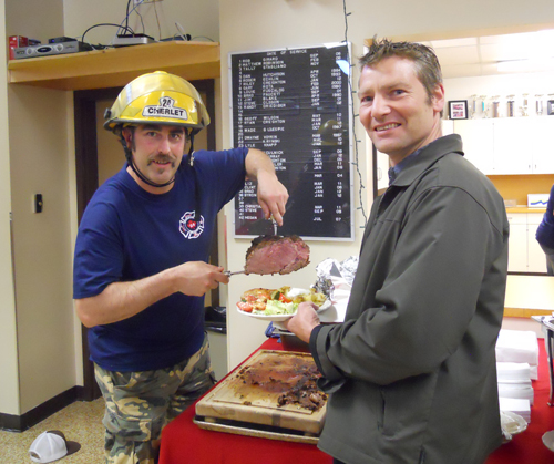 Rotarian Graham Harper gets a nice slab of roast beef during the barbeque the Fire Rescue Service held to show their appreciation to the Rotary Club and the Ladies Hospital Auxiliary. Photo courtesy of the Revelstoke Fire Rescue Service