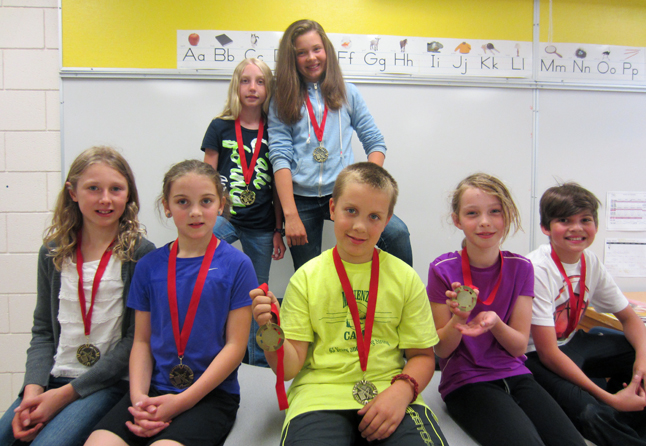 Arrow Heights Elementary Students proudly show off their math competition medals.  Grade 7/8 Competition Participants Back Row: Kate Granstrom (2nd Place at AHE), Alana Brittin (1st Place at AHE)  Grade 3/4 Competition Participants Front Row: Emily MacLeod (4th Place at AHE), Kaity Herle (3rd Place at AHE), Josh Larsen (2nd Place at AHE), Megan Hoshizaki (5th Place at AHE), Stefan Spataro (6th Place at AHE) Note: Josh is holding the Arrow Heights 1st Place winner medal for Griffin Velichko who recently moved to Alberta.  Griffin will be receiving his medal in the mail shortly. Julian Corbett photo 