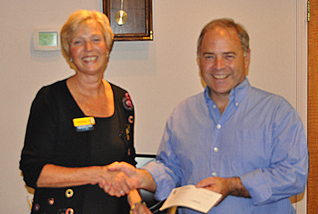 RBC Branch Manager Lynne Welock presents Mayor David Raven with a cheque for $25,000 during Tuesday's regular Council meeting. The money is the bank's generous  contribution to the planned development of an age-friendly outdoor exercise area at Kovach Park. RBC has been in Revelstoke at the corner of Mackenzie Avenue and First Street West for 50 years and Lynne said the bank would like to hear stories from customers. The branch is also planning an open house for July 26. David F. Rooney photo
