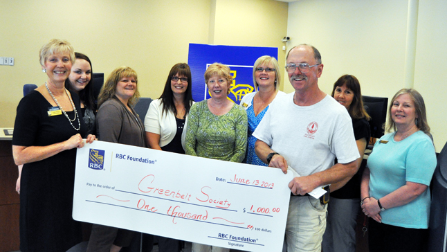 RBC Manager Lynne Welock (left) and her staff present Don Pegues (right) and Barb Kemerer (center) of the Illecillewaet Greenbelt Society with a $1,000 cheque from the RBC Foundation on Thursday. The Greenbelt Society used the money to purchase gravel for one of its trails. Lynne and her staff even came down to the Greenbelt a couple of weeks ago to help work on the trail. Now that's community spirit. David F. Rooney photo