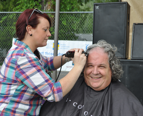 Wayne Murray, always a good sport, gets shorn by Michelle. Wayne has been having his head shaved as a fund raiser for the last five years. David F. Rooney photo