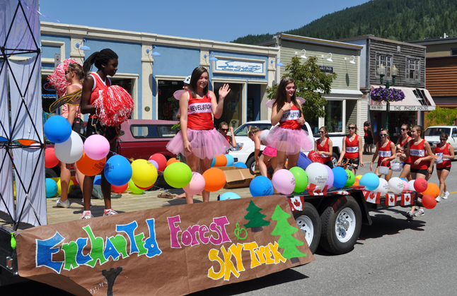 These smiling cheerleaders waved and smiled atop of the Enchanted Forest and Skytrek float. David F. Rooney photo