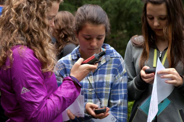 Sara Howatt, Anne-Marie Duchesne and Emma Knight Flood explore how to use a GPS. Natalie Harris photo courtesy of Parks Canada 