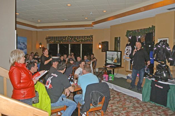 The Revelstoke Snowmobile Club's Kathy Burke (left) watches some of the action at the recent DVD release party and fund-raiser it held at the Hillcrest in conjunction with the Thunder Team  . Dusty Weideman photo