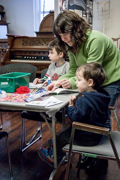 More activities were to be found on the upstairs level of the museum. Here a mom helps her children create Christmas Cards. Jason Portras photo