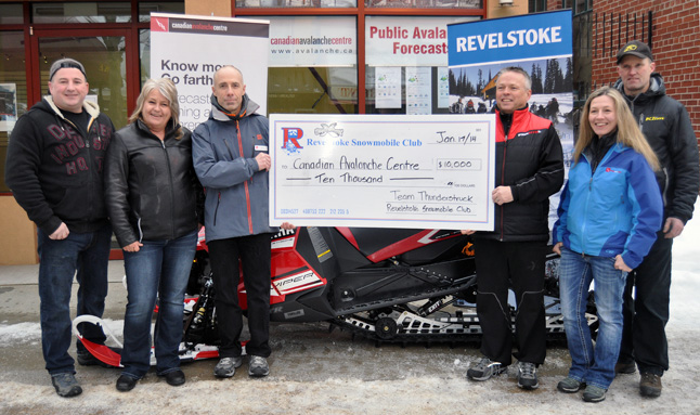 Canadian Avalanche Centre Executive Director Gilles Valade (third from the left) receives a $10,000 cheque from Randy Swenson of Thunderstruck Films. Also in the photo are, from left to right, are Jeff Rosner, Cathy Burke, Carole Savage and Greg Byman of the Revelstoke Snowmobile Club. Swenson and colleague Jim Phelan of Helena Montana helped raise the money during the Snowmobile Club's annual fund-raising dinner at the Hillcrest Hotel. The presentation took place bright and early on the morning of Friday, January 17. David F. Rooney photo