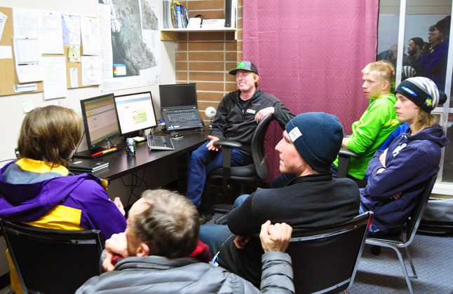 Avalanche Forecaster Joe Lammers (center) holds sway as he answers questions from some of the many people who attended an open house at the Canadian Avalanche Centre's Forecasting Office at 101A Second Street East on Thursday, January 23. Lammers and his colleagues produce regular avalanche forecasts that are key pieces of information for the thousands of snowmobilers, skiers snowboarders and others who frequent the winter-clad mountains of British Columbia, Alberta and the Yukon. David F. Rooney photo