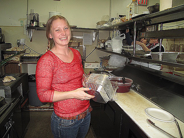 Val Mathes worked in the kitchen preparing take-away food with Lynne Welock (not shown in this image). The food is provided through donations by local businesspeople. Laura Stovel photo