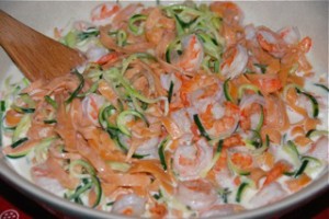Pink pasta with green zucchini spirals and prawns makes this a great presentation.