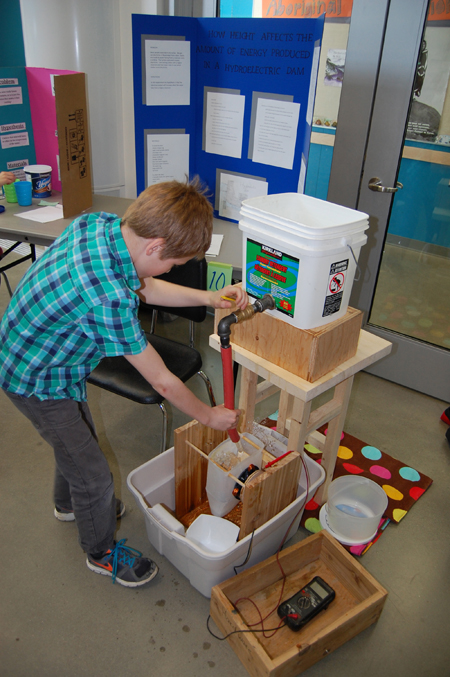 Alex Jay demonstrates how height affects the power generated by hydroelectric project. David F. Rooney photo