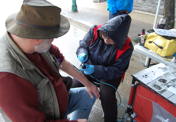 Maddie Cole applies a (Thankfully!) temporary tattoo to Current publisher David Rooney's forearm. Bekah McLeod photo