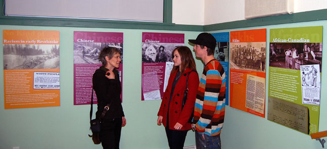 Laura Stovel talkis with graphic designer Rachel Petrie and her friend Jason Schneider about the new display about the history of racism in Revelstoke. Laura researched and wrote the text for the six display panels and Rachel designed them. As a note of interest, Laura also created the first racism display that was shown for many years at the Revelstoke Museum & Archives. These new panels were unveiled at the AGM and are now on display at the Revelstoke branch of the Okanagan Regional Library. David F. Rooney