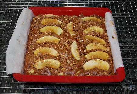 Apple cake in a silicone pan with parchment for easy removal. You can use a glass baking dish instead, and serve it right from the pan.