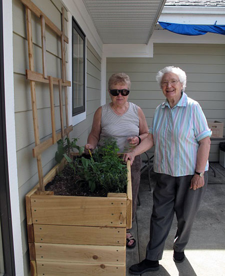 Donna Kaiser and Mary Doebert admire the herbs they just planted. Laura Stovel photo