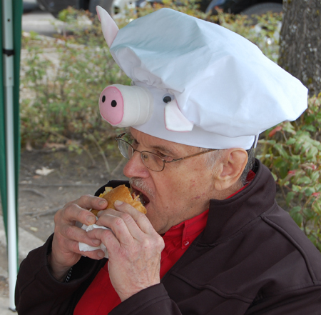 Speaking of comfy, Steve Bender looks rather at ease chowing down on a smokie at the Home Hardware sale. David F. Rooney photo
