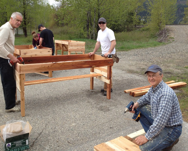 (From left to right) Alan Dennis, Kelly Pettus, Bryan Thomas, Andrew Clark and Uri Naprstek assemble wheelchair accessible planters for seniors’ residences in Revelstoke, including the Cottages and Moberly Manor. Two wheelchair planters will remain in the Visual Arts Centre garden and can serve as functional models.