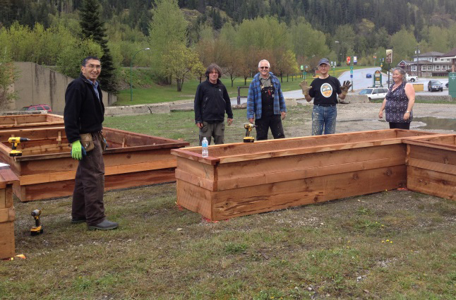 Construction leader Ken Talbot (centre) admires the day’s handiwork with volunteers Mas Matsushita (far left), John Townley, Uri Naprstek and Sue Davies. Talbot volunteered long hours of work designing the planters and preparing the wood before the working bee on Saturday.