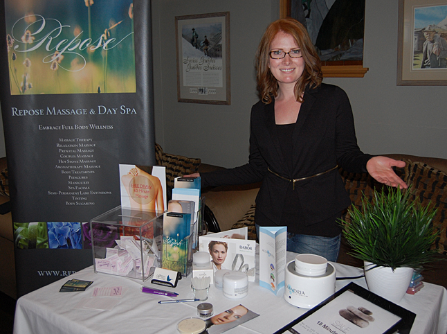 Ashley Sumner of Repose Massage & Day Spa shows off her display of products and services. David F. Rooney photo