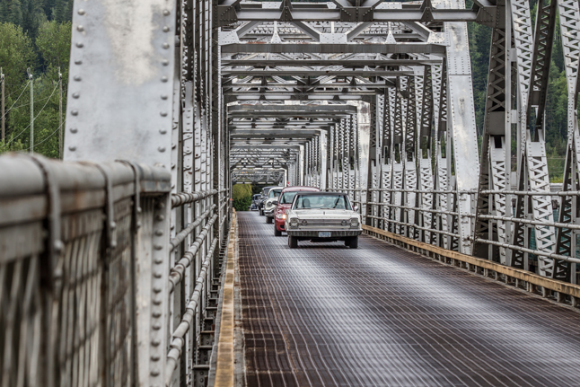On the way to the Revelstoke Dam, a parade of classic cars crosses the Big Eddy Bridge. Jason Portras photo