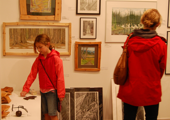 Mom may have her eye on a painting or print, but this young girl liked the smaller three-dimenstional work on offer at ArtFirst on First Street West.  David F. Rooney photo