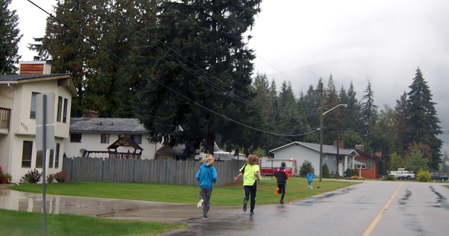See these kids running along Hay Road in Upper Arrow Heights? They're not training for a marathon but scurrying ahead to go door-to-door to collect donations. David F. Rooney photo