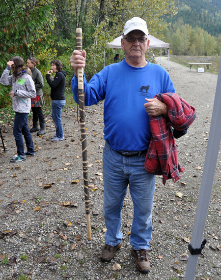 Veteran hunter and fisherman Cyril Keates brandishes the ornately carved walking stick he brought to the Kokanee Festival where he helped provide security in case of bears. David F. Rooney photo