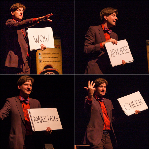 Ryan Pilling helped the audience act out typical reactions to magic shows. He then had a little girl from the audience indirectly help him rearrange the placards. When done, he flipped them over, creating the sentence “I knew this would happen.” Jason Portras photo