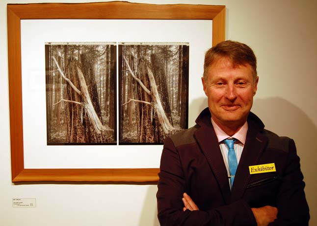 Kip poses with his image entitled, The Odd Couple. Like most of the other images in this show it is meant to be seen through viewer Kip painstakingly crafted by hand. A retired CPR employee Kip has for years worked diligently to produce excellent photographic artworks for sale and for exhibition. Among his accomplishments was an award from the Banff Mountain Photography competition in 2004. David F. Rooney photo