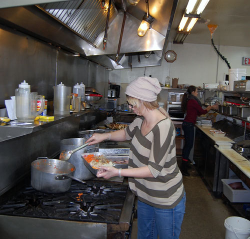 Kristine Osachoff puts together a meal-to-go in the kitchen at the Old Frontier. David F. Rooney photo