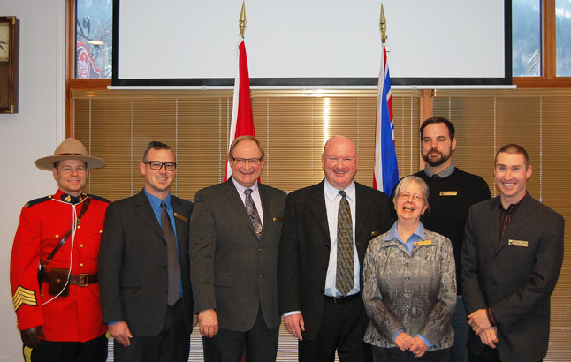Mark McKee and five of Revelstoke's new City Councillors — Linda Nixon, Scott Duke, Trevor English, Aaron Orlando and Gary Sulz — [pse with RCMP Staff Sgt. Kurt Grabinsky after they were were sworn in as our new political leaders on Monday, December  1. Councillor-elect Connie Brothers was not out of the country and will have to be sworn in when she returns. David F. Rooney photo