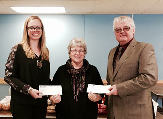 Sabina Spahmann (left) and Terry Crane of Investors pose with Community Connections’ Food Bank Manager Patti Larson on Friday, January 16, as they presented her with a donation of $500. Photo courtesy of Sabina Spahmann
