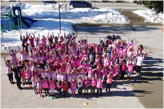 Arrow Heights Students gathered outside for a picture creating a 'Sea of Pink’, on February 25th  2015. Photo by Todd Hicks. Caption by Emily MacLeod and Amelie Delesalle