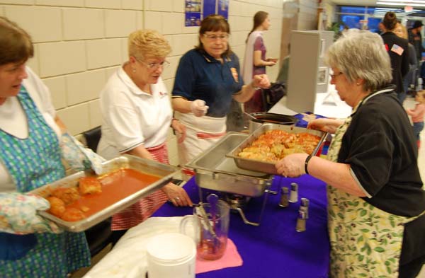 Susan Dosot brings a fresh pan of cabbage rolls to the Eastern European table run by the ladies of the Royal Canadian Legion Branch 46. David F. Rooney photo