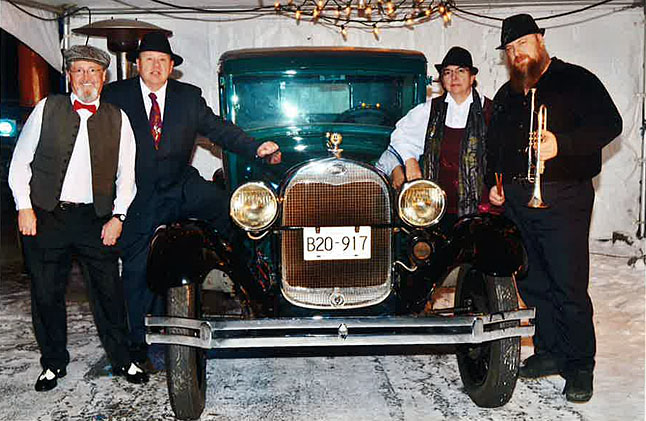 Relative Jazz will be performing at the Jazz Club in the Selkirk Room at the Regent on Friday, March 13, from 7 pm to 9 pm Relative Jazz is a four-person combo featuring John Baker, Wendy Lucas, Steve Earle and Bob Fournier. Here they are posing like 1930s gangsters with George Hopkins’ classic car. Photo courtesy of Jesse Holdener Photography