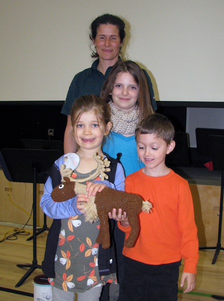Sarah Boyle, Alyssa Bollfer and Kindergarten students Issac Defeo and Jamie Reynolds holding a caribou made by Cathy English.  Their class won the Quarter for a Caribou coin drive. Eleanor Wilson photo