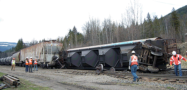 Workers study the derailment. David F. Rooney photo