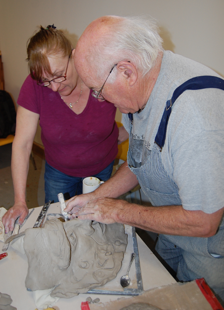 Brenda Strutt pays close attention as Bob applies some hands-on instruction. If you'd like to learn how to make ceramics and missed this chance please contact the Visual Arts Centre about future workshop opportuniti4es. David F. Rooney photo