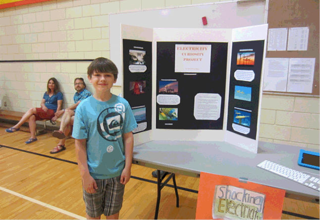 Mitchell Legebokow shows off what he learning about Electricity in the AHE gym on May 15. “Did you know lightening is 27,000° Celsius?” he asked. “That’s six times hotter then the sun!” Todd Hicks photo. Caption by Amelie Delesalle