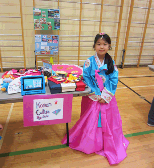 Seoha Lee introduced everybody to Korean culture at the Curiosity Project display in the AHE gym. Todd Hicks photo. Caption by Amelie Delesalle