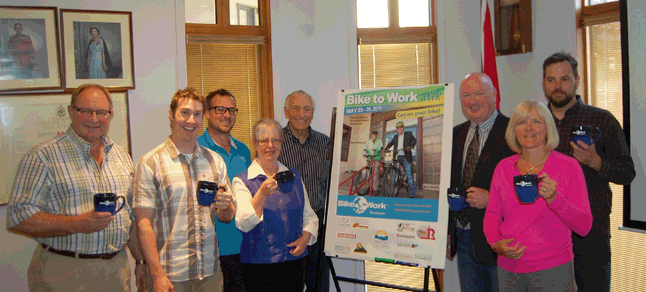 Some of this year's Bike to Work Week cyclists could well be Mayor Mark McKee and members of City Council, shown here posing with Geoff Battersby (centre) who came before them on Tuesday, May 12, to promote the May 25 - 31 event. Each member of Council posed here with the special BTWW mugs they received from the local BTWW Committee. Get ready to pedal boys and girls! David F. Rooney photo