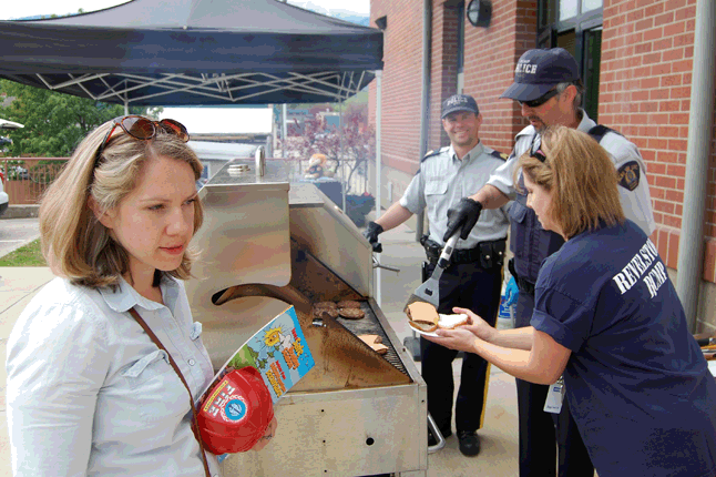 Police Week continues and the Revelstoke RCMP’s community BBQ over lunch on Thursday was a success, said Staff Sgt. Kurt Grabinsky, show here (centaur left) burning burgers with Auxiliary Const. Aaron Volpatti. “Over $200 was raised to donate to the Revelstoke Women's Shelter,” he said. “There were many youth and adults who thoroughly enjoyed looking at the police equipment and pressing the siren in the police cars.” David F. Rooney photo