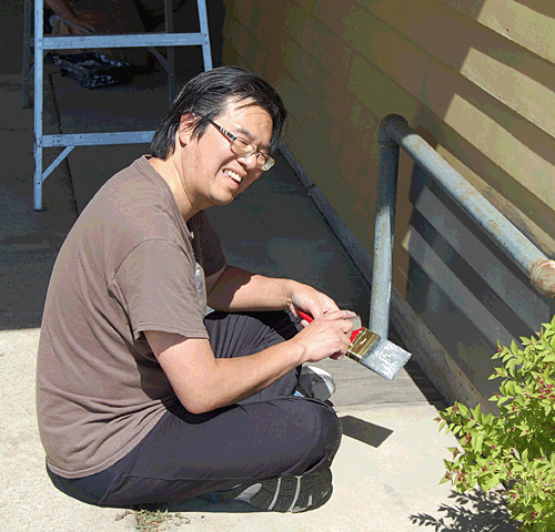 Rotary Club member Steven Hui looked a little well-baked as he painted the lower part of a wall. David F. Rooney photo