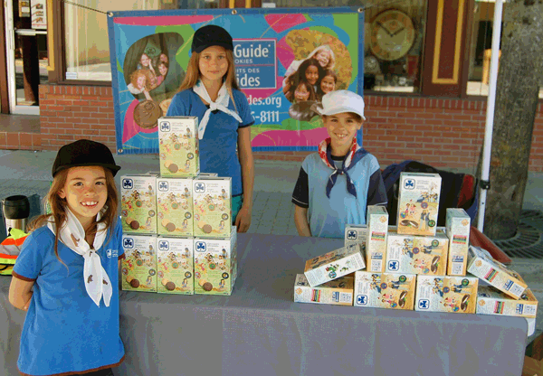 If you wandered down First Street West you couldn't pass these nice young ladies — Madeline Hunt (left, Shaunacy Alm and Emily Hunt — without paying a box or two of their Girl Guide cookies. David F. Rooney photo