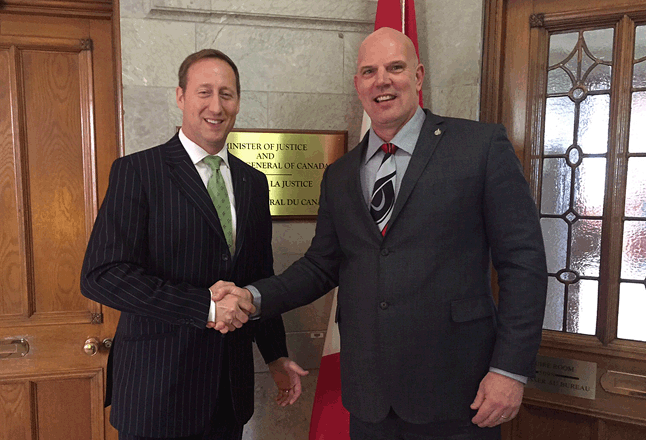 Justice Minister Peter MacKay announced his resignation Friday, May 29, prompting MP David Wilks to say he was honoured that one of his last acts was to visit Kootenay-Columbia riding. Here Wilks (right) shakes hands with  the out-going Justice Minister who engineered the Progressive Conservative Party of Canada's merger with the Canadian Alliance to form the Conservative Party of Canada in 2003.  Photo courtesy of MP David Wilks