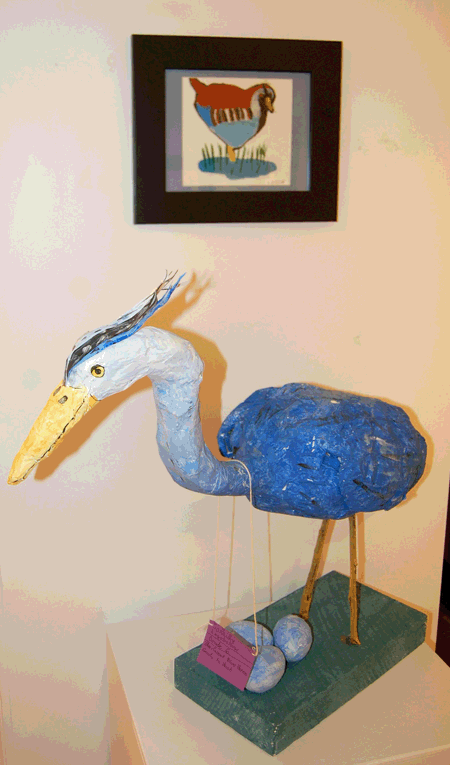The Great Blue Heron Ready to Hunt By Cassidy Legelbokow and, in back, Bird at a  Pond By Brandon Donato 